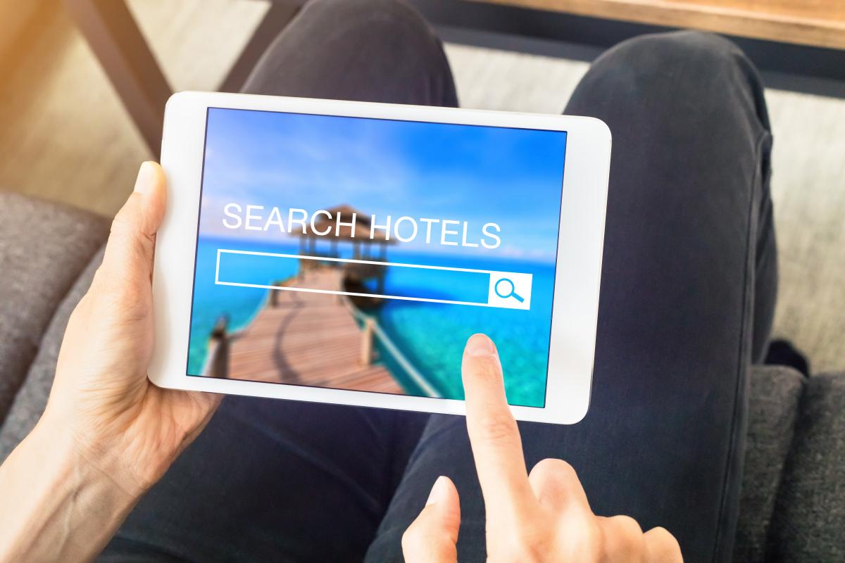 an tablet with a "search hotels" screen