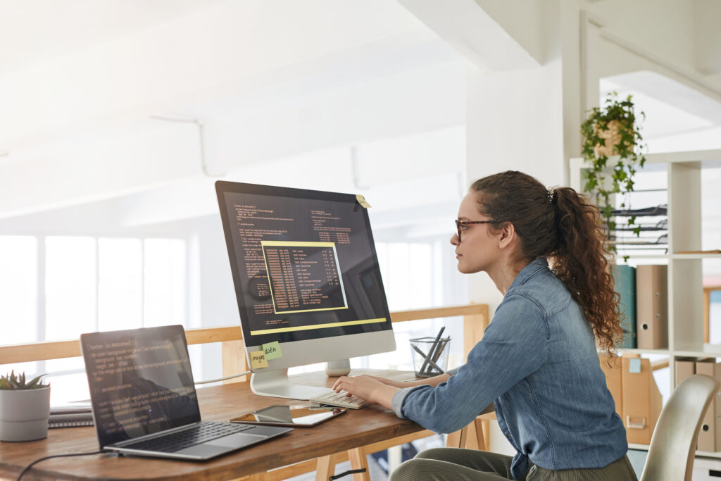 Young Woman Writing Software Code