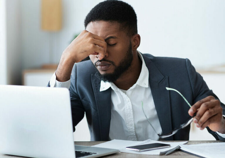 African american businessman tired of long time work on laptop stock photo